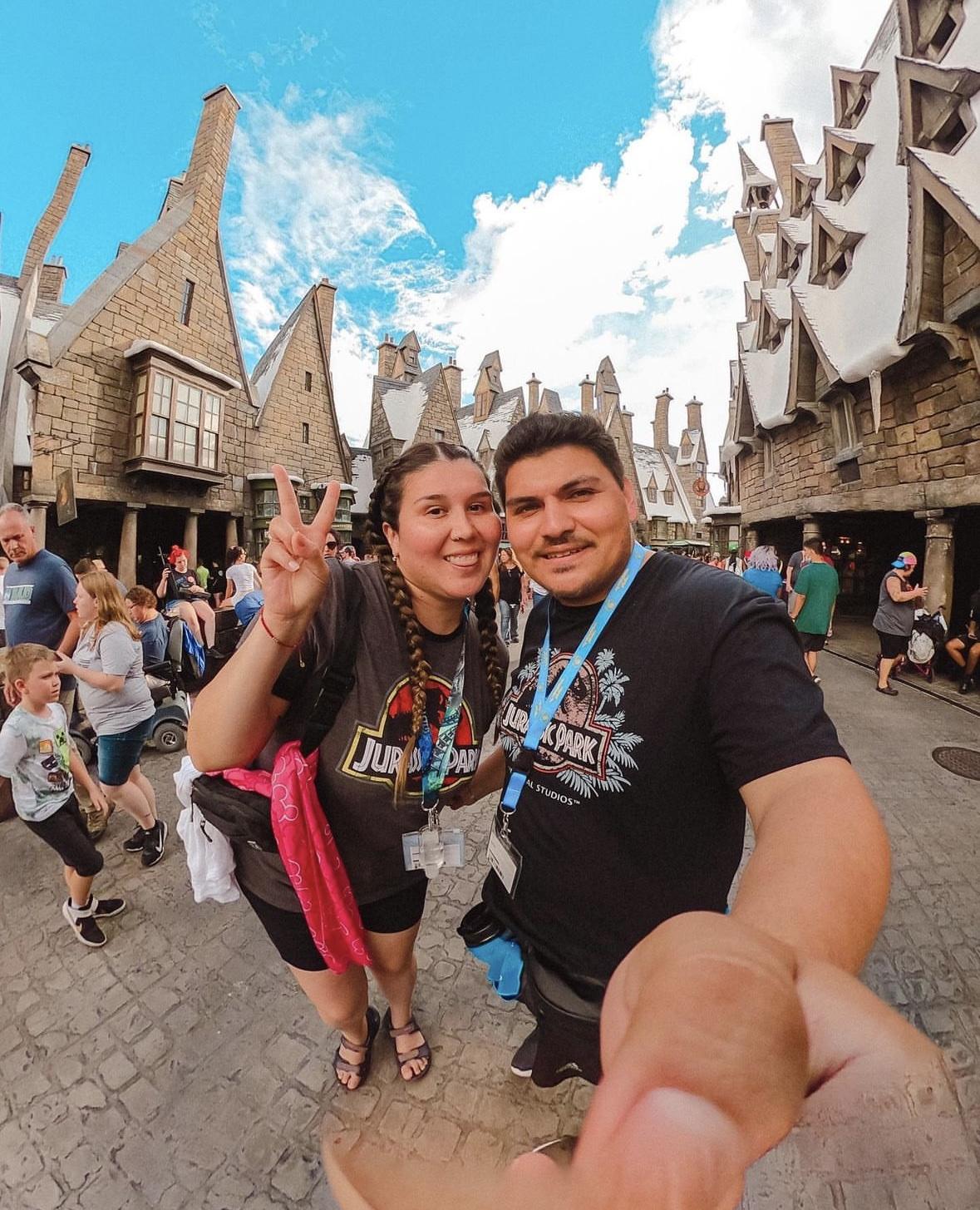 Couple selfie in magical fantasy theme park with whimsical village backdrop