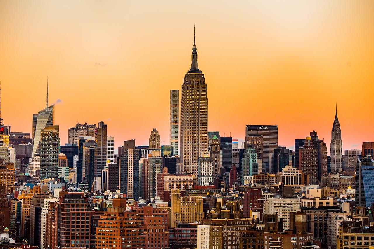 Empire State Building and New York City skyline glowing at sunset, New York activity