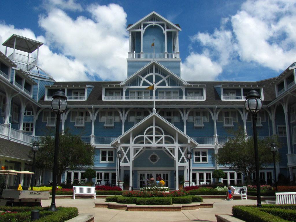 Front exterior of Disney Beach Club Resort with light-blue facade and white trim