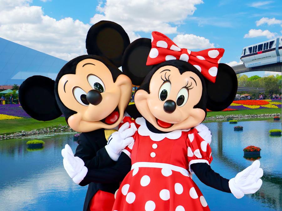 Mickey and Minnie at Epcot with the monorail in the background, highlighting disney vacation packages
